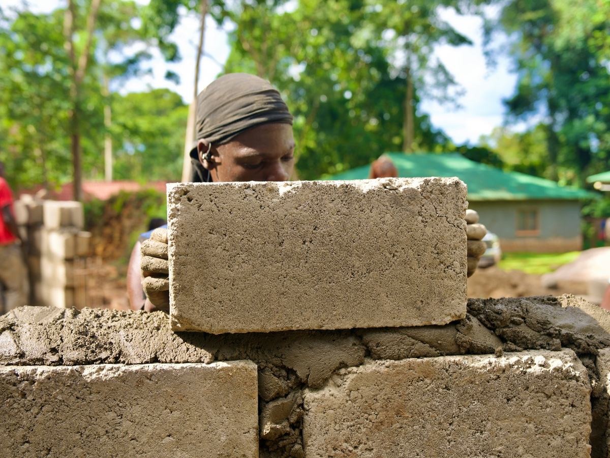 A builder laying concrete blocks