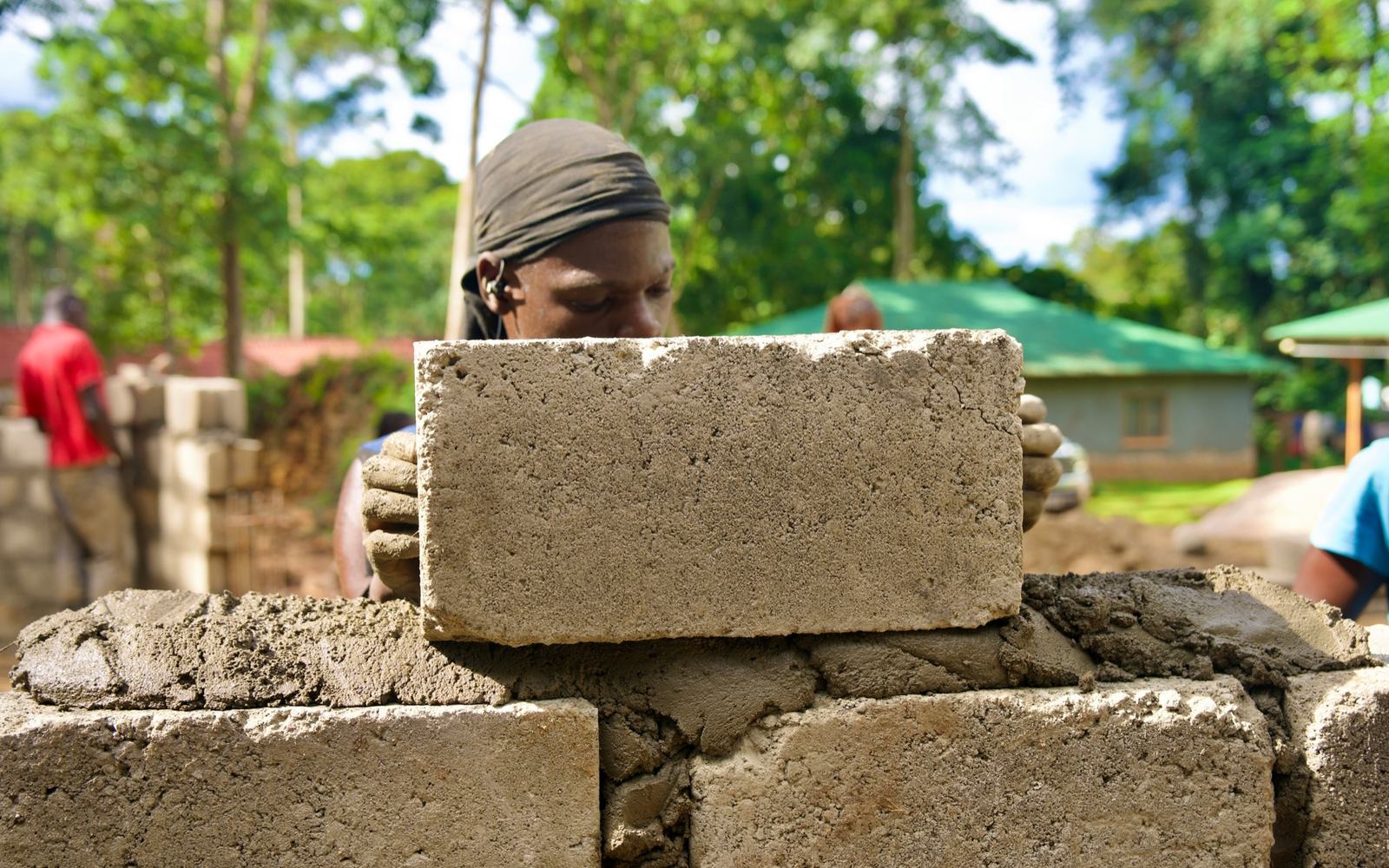 A builder laying concrete blocks