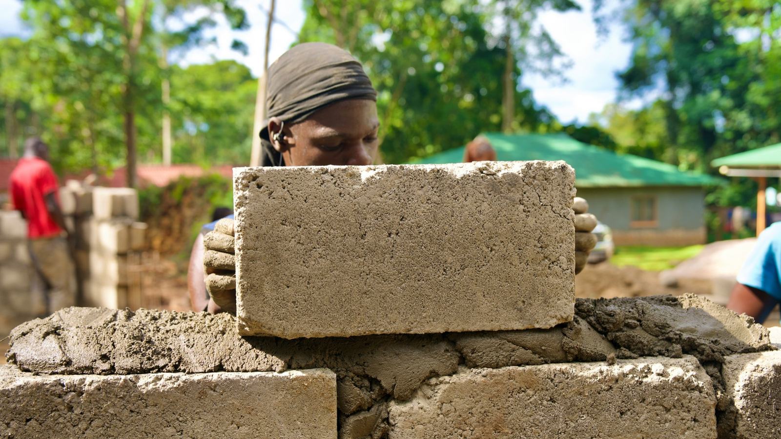 A builder laying concrete blocks